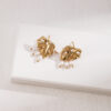 Verdant Bloom Earrings – Gold-plated monstera leaves with delicate pearl accents, inspired by nature’s beauty.
